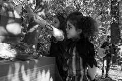 A girl in costume reaches for a free giveaway at the annual Come as You Art event on the Karl Stirner Arts Trail.